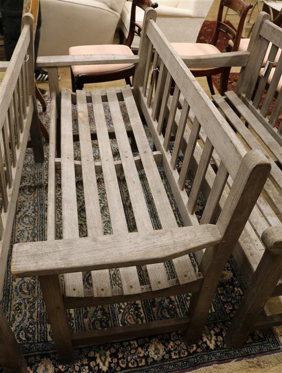 A teak garden bench with slatted seat W.128cm